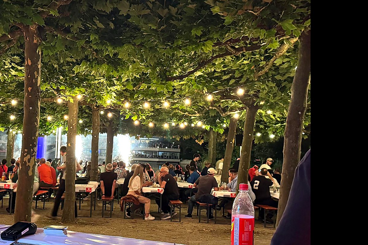 Sommerabend bei Schlemmen am See in Böblingen mit Gästen unter Bäumen und Lichterketten